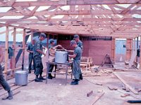 Serving the first meal in the half finished mess hall