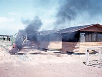 Using diesel fuel to burn out the 55-gallon drums cut in half that were used in the latrines at Service Battery