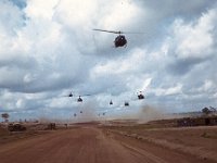 Infantry lifting off in Huey slicks from air strip at Phuoc Vinh