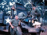1LT Cecil Gardner and crew repair a broken truck on the road to Phuoc Vinh