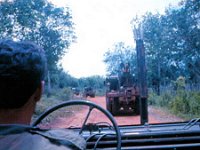 The unpaved, laterite-covered narrow road to Phuoc Vinh