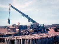 Unloading 8-inch ammunition beside the air strip at Phuoc Vinh