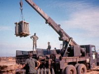 Unloading two 3-round pallets of 8-inch ammunition