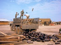 Upon return to Long Binh, unloading the refuse of war, 105mm artillery canisters probably from the 1-5th Arty at Phuoc Vinh