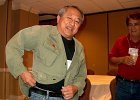 &#34;Let&#39;s see now, I let a little air out here and . . . &#34; Les Higa once again proves he can still get into his old field jacket with Roy Maldonado looking on skeptically.