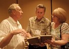 Bill Roznowski shows B J &#38; Linda Bowles his photos
