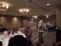 Pedro Agost (R) presents Michael Swanson with a "John Williams" print after his name was called in the drawing.